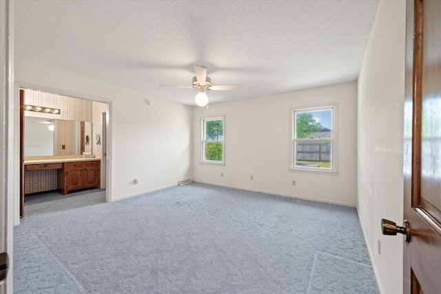 2912 Doncaster Dr, Charleston, SC 29414 - unfurnished bedroom with carpet floors, baseboards, ensuite bathroom, a textured ceiling, and ceiling fan