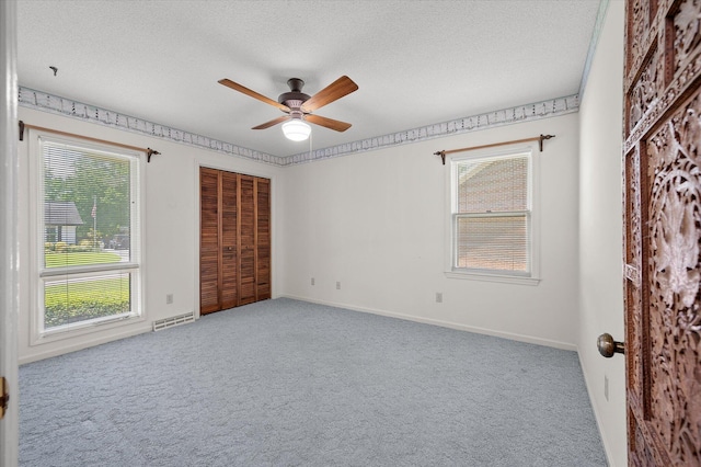 2912 Doncaster Dr, Charleston, SC 29414 - unfurnished bedroom featuring carpet floors, multiple windows, a textured ceiling, and a closet