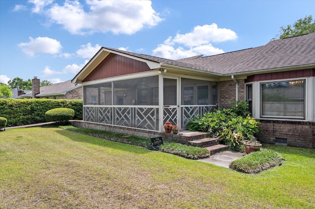 2912 Doncaster Dr, Charleston, SC 29414 - view of side of property featuring roof with shingles, a sunroom, a lawn, and brick siding