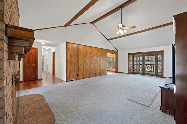 2912 Doncaster Dr, Charleston, SC 29414 - unfurnished living room featuring carpet floors, a ceiling fan, high vaulted ceiling, beam ceiling, and a brick fireplace