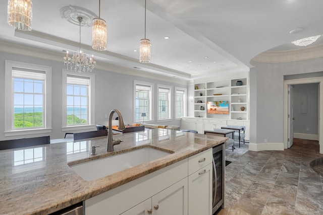 1 King Unit 702, Charleston, SC 29401 - kitchen featuring a tray ceiling, a chandelier, wine cooler, open floor plan, and decorative light fixtures