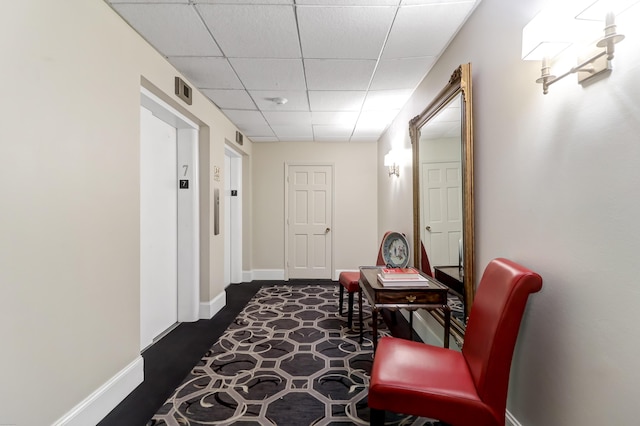 1 King Unit 702, Charleston, SC 29401 - hallway featuring a drop ceiling and dark wood-type flooring