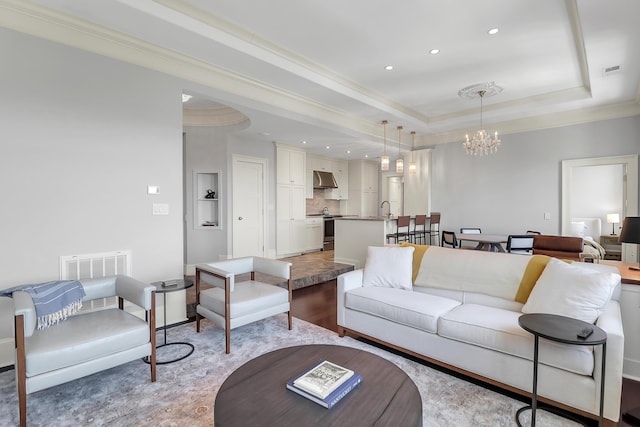 1 King Unit 702, Charleston, SC 29401 - living area featuring a chandelier, a tray ceiling, crown molding, and recessed lighting