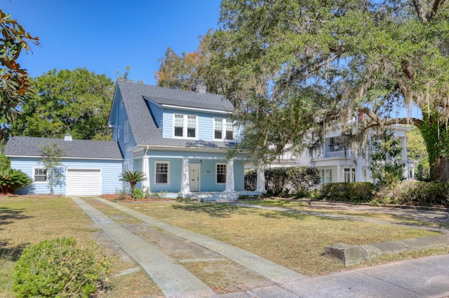 view of front of property with a front lawn, covered porch, and a garage