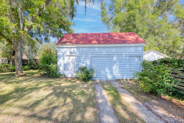 view of outbuilding featuring a lawn