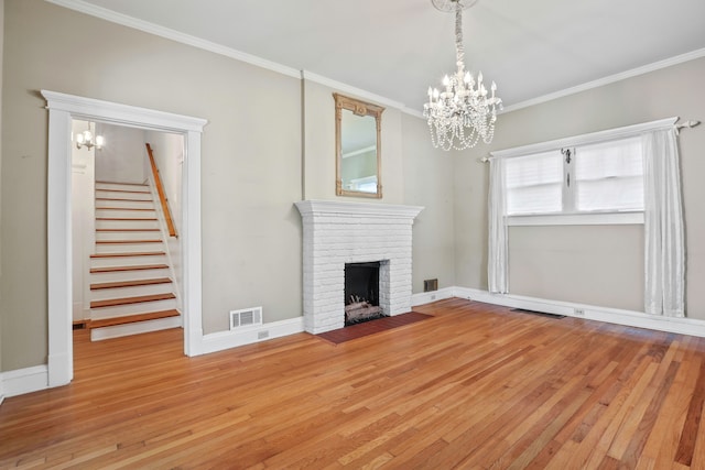 unfurnished living room with light hardwood / wood-style floors, crown molding, and a fireplace