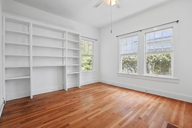 empty room featuring wood-type flooring and ceiling fan