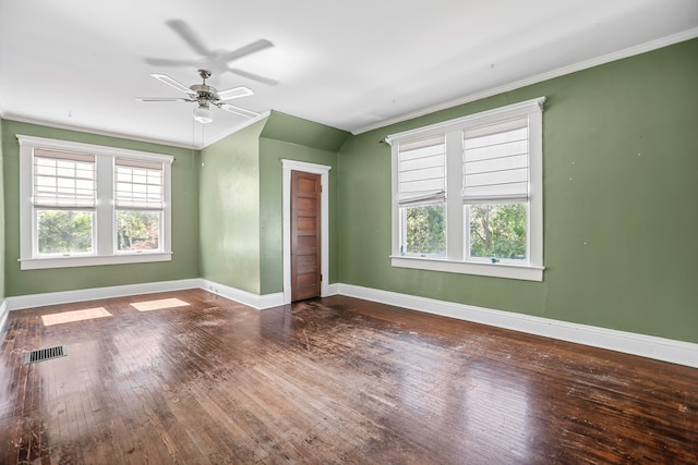 empty room with wood-type flooring and ornamental molding