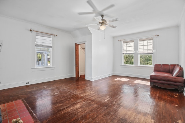 interior space with dark wood-type flooring, ceiling fan, ornamental molding, and a wealth of natural light