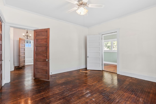 spare room with ornamental molding, dark hardwood / wood-style flooring, and ceiling fan with notable chandelier