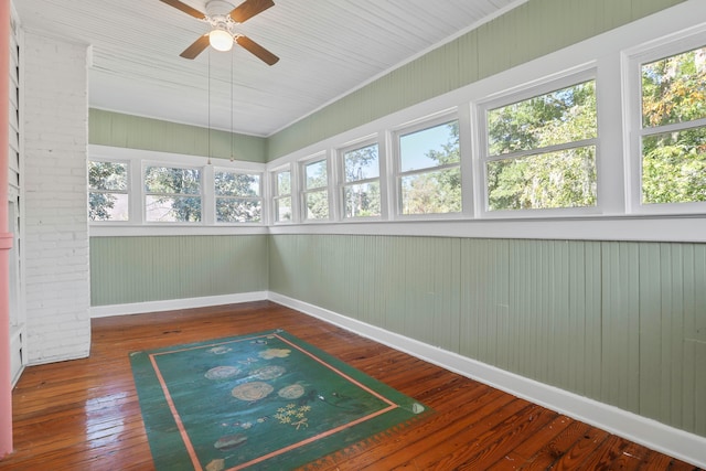 unfurnished sunroom with a wealth of natural light and ceiling fan