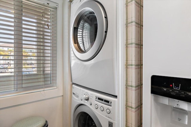 laundry area featuring stacked washer / drying machine