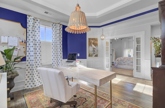 home office featuring hardwood / wood-style floors, crown molding, and a chandelier