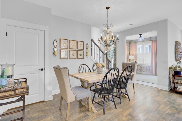 dining room featuring a chandelier and wood-type flooring