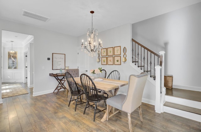 dining room with an inviting chandelier and dark hardwood / wood-style floors