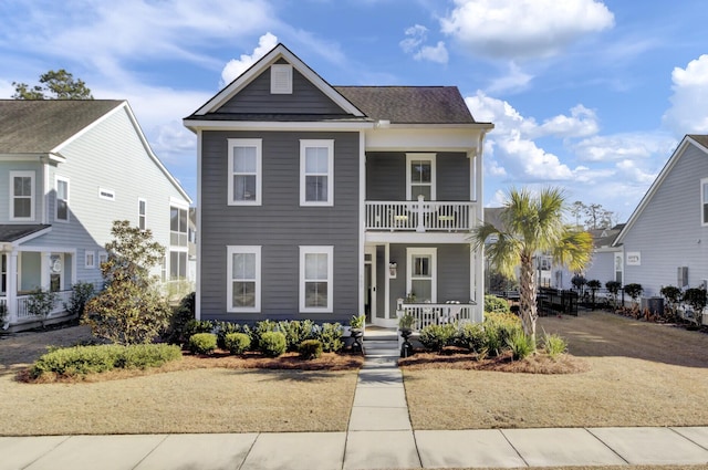 view of front of property featuring a porch and a balcony