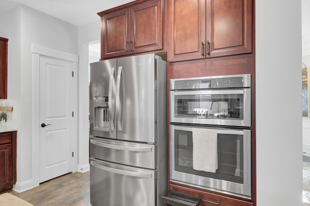 kitchen featuring stainless steel appliances and dark wood-type flooring