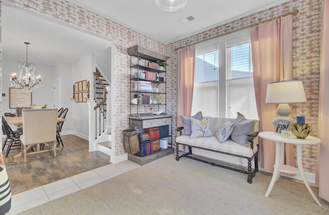 sitting room with tile patterned flooring and an inviting chandelier