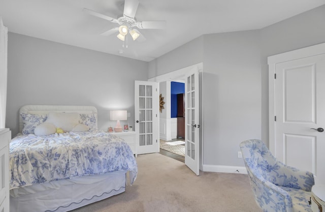 bedroom featuring ceiling fan, light colored carpet, and french doors