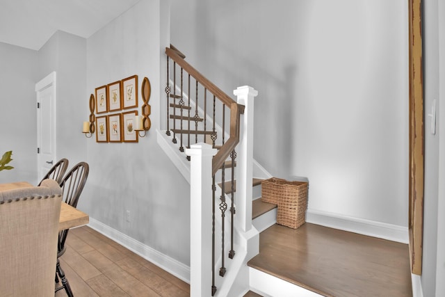 staircase with hardwood / wood-style flooring