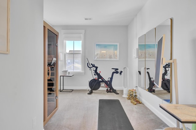 exercise room with light colored carpet