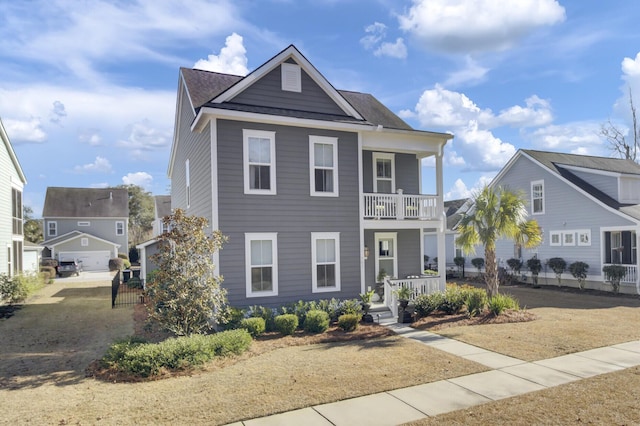 view of front of property featuring a balcony and a porch