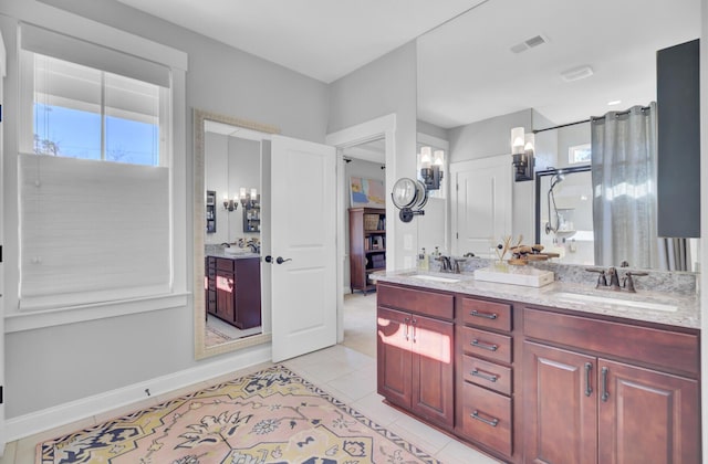 bathroom featuring vanity, walk in shower, and tile patterned flooring