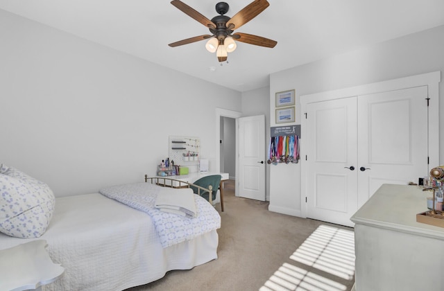 bedroom with light carpet, a closet, and ceiling fan