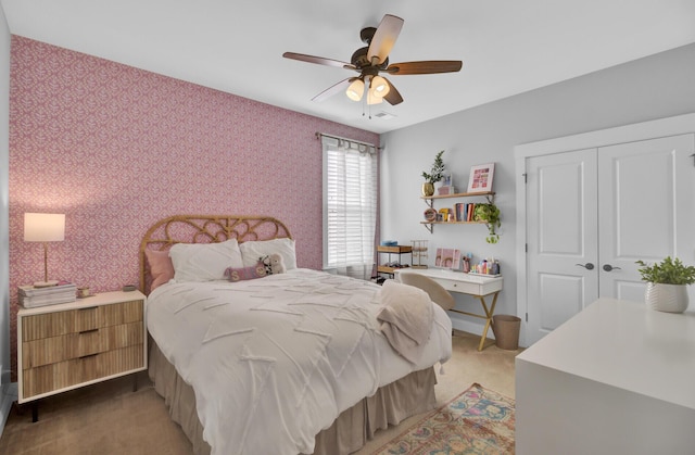 carpeted bedroom featuring a closet and ceiling fan