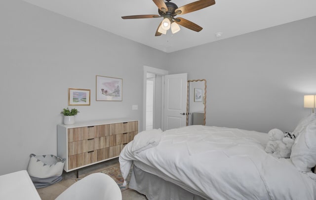 bedroom featuring ceiling fan and dark carpet