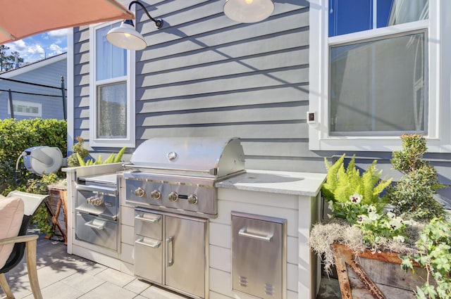 view of patio with a grill and an outdoor kitchen