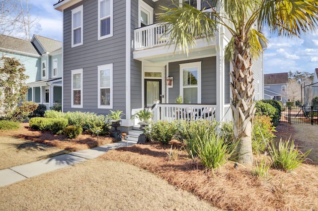 view of front of property featuring covered porch and a balcony