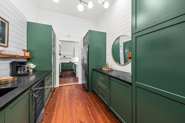 interior space with dark wood-type flooring, wood walls, and wine cooler