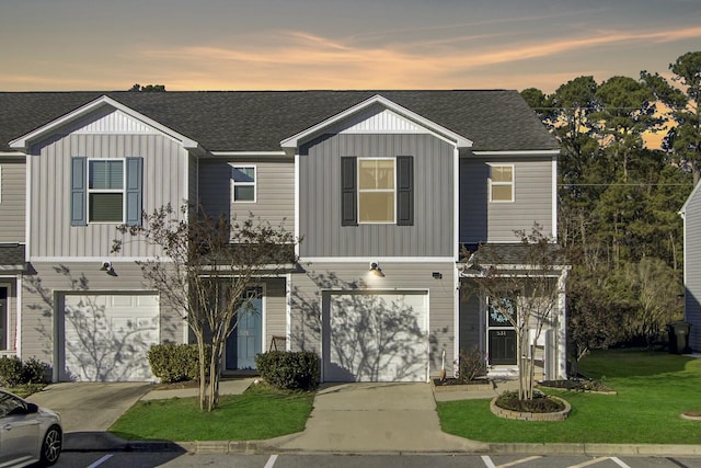 view of front of house featuring a garage and a yard