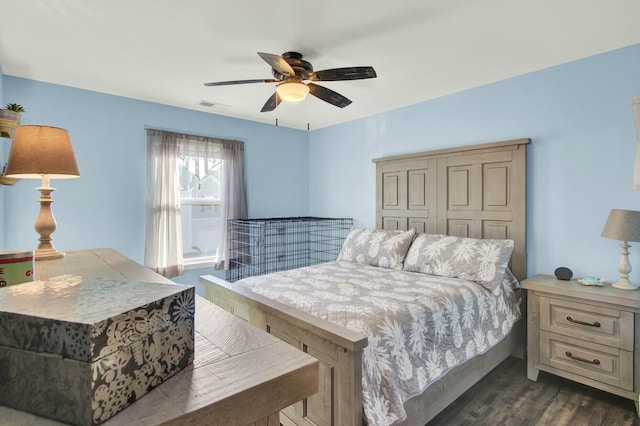 bedroom featuring dark hardwood / wood-style flooring and ceiling fan