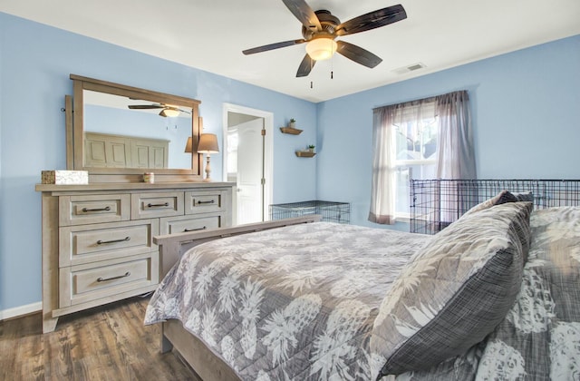 bedroom with dark hardwood / wood-style floors and ceiling fan