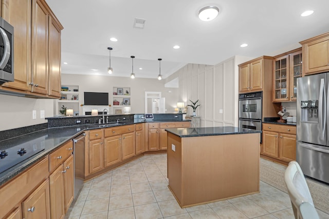 kitchen featuring stainless steel appliances, a sink, glass insert cabinets, a peninsula, and dark stone countertops