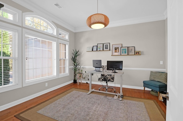 office area with crown molding, wood finished floors, and baseboards