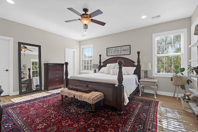 bedroom with wood finished floors, baseboards, recessed lighting, and ceiling fan