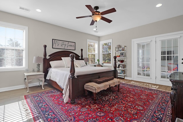 bedroom featuring wood finished floors, baseboards, recessed lighting, ceiling fan, and access to exterior