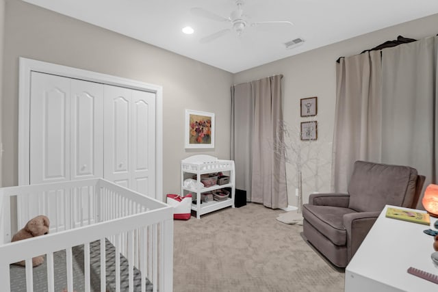 bedroom featuring light colored carpet, a closet, a ceiling fan, and recessed lighting
