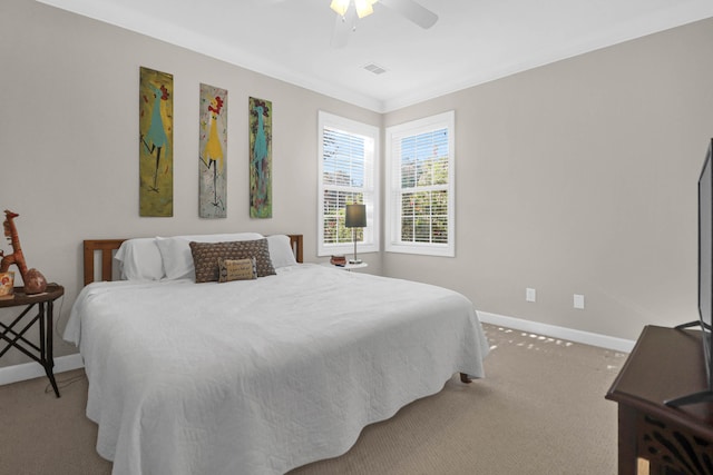 carpeted bedroom featuring baseboards, a ceiling fan, and crown molding