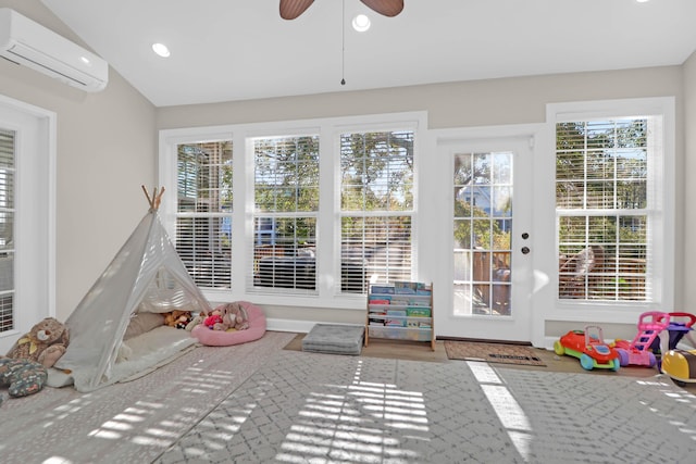 playroom featuring a wall mounted AC, a ceiling fan, recessed lighting, vaulted ceiling, and wood finished floors