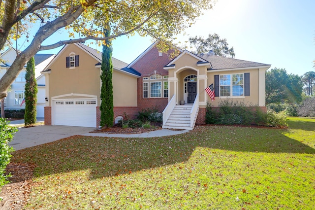 view of front of property featuring brick siding, a front yard, stucco siding, and driveway