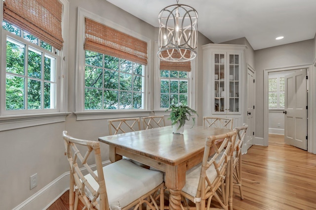 dining room with a chandelier and light hardwood / wood-style floors