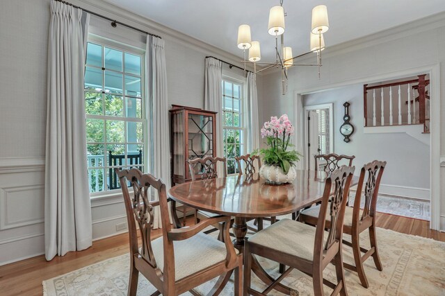 dining room with a chandelier and light hardwood / wood-style floors