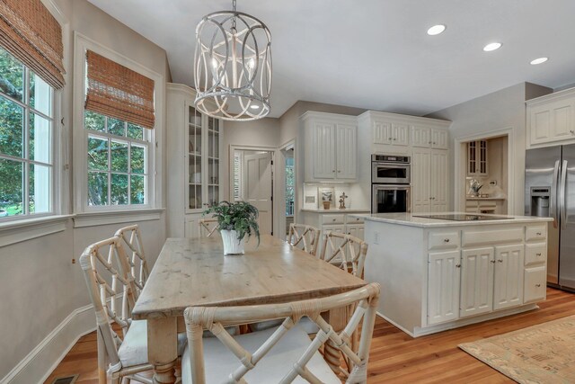 kitchen with a center island, appliances with stainless steel finishes, and light hardwood / wood-style floors