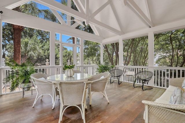 sunroom with lofted ceiling with beams