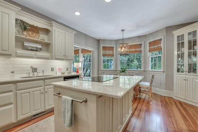 sunroom / solarium featuring a fireplace, vaulted ceiling, and plenty of natural light