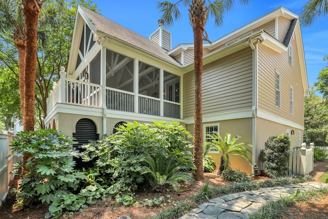 view of side of property with a sunroom